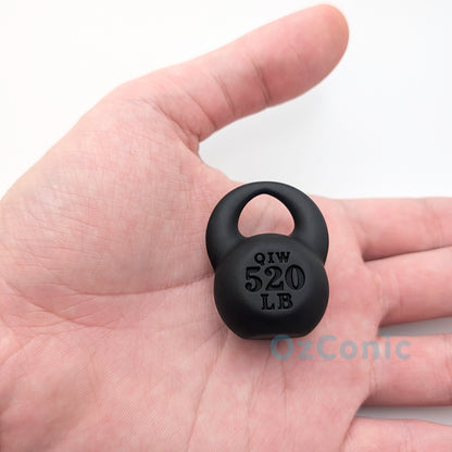 Small black weight plate held in a hand with 'OzConic' branding.