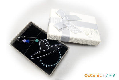 Got Broach design in a box, next to a wrapped gift