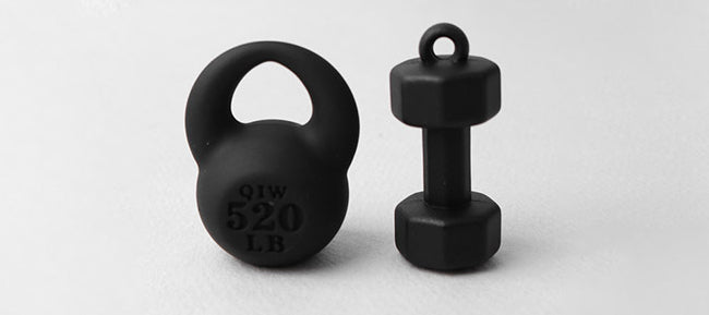 Black kettlebell and dumbbell on a light gray background